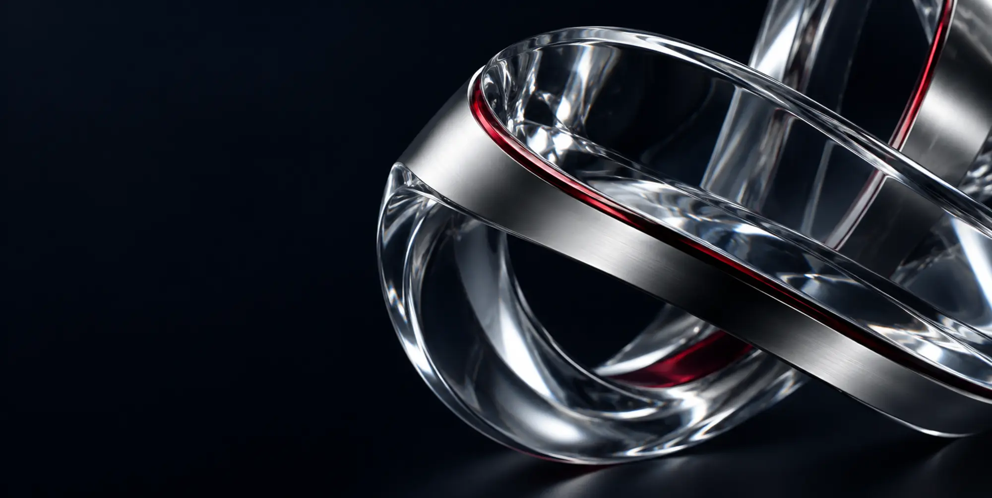 Precision glass and titanium ribbons with a deep red edge, photographed in dramatic studio light.